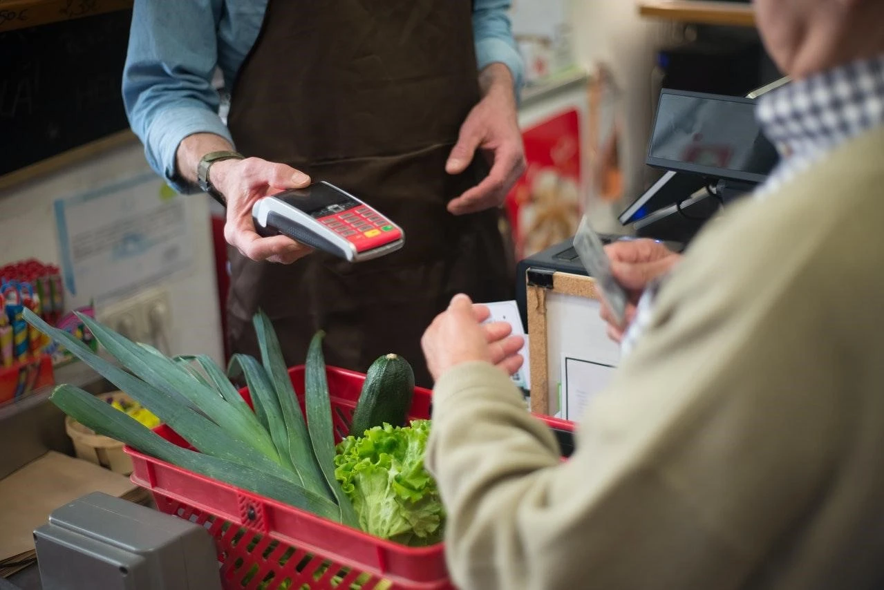 Cashier collecting credit card payment from a customer