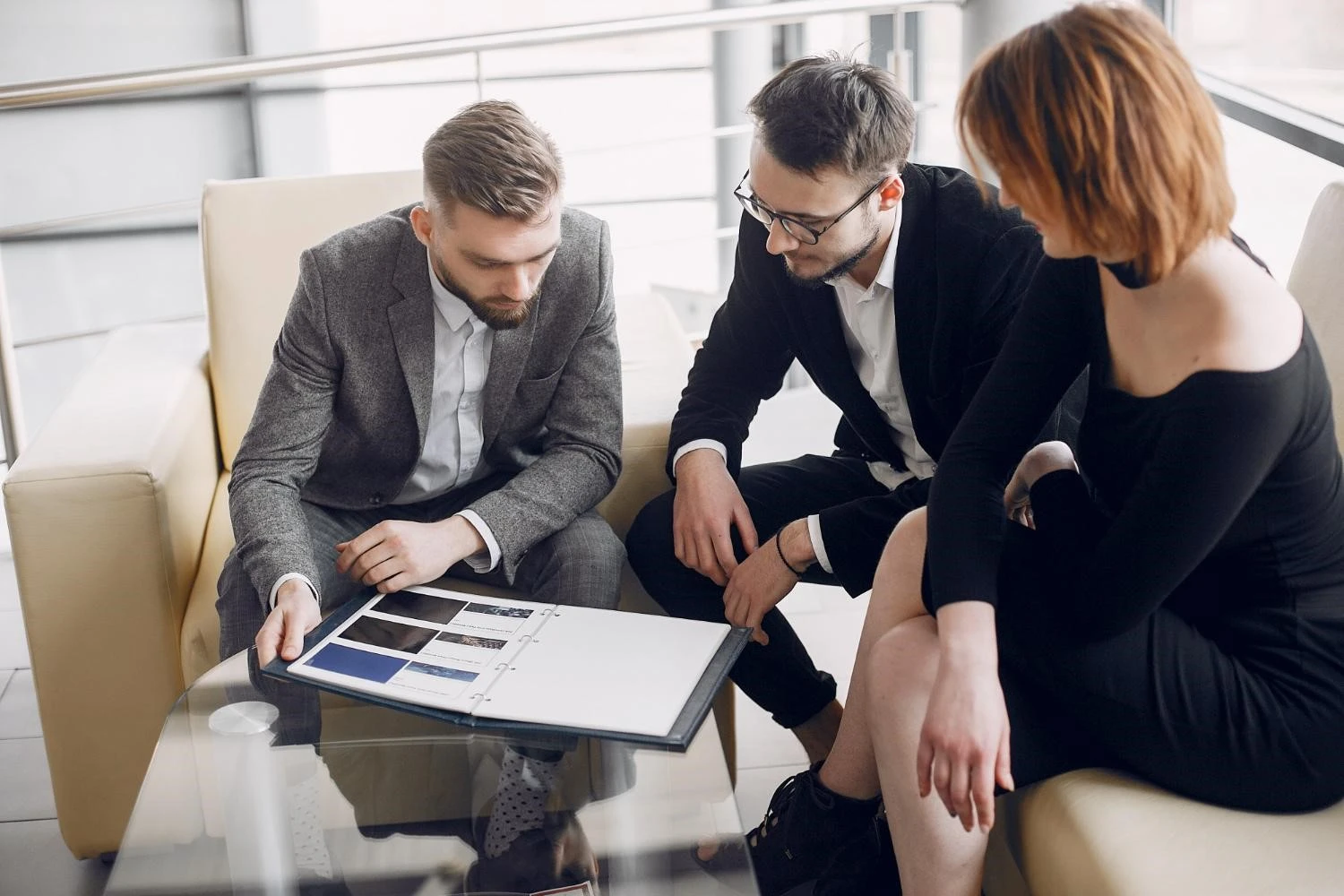 Manager and workers looking at an open folder