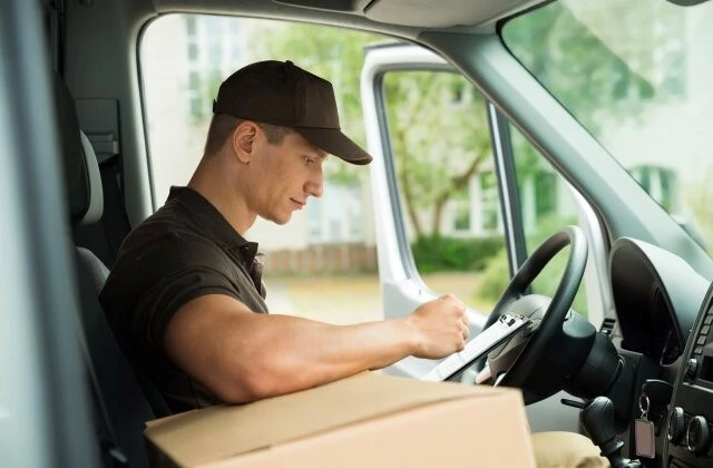 Man driving a truck with packages