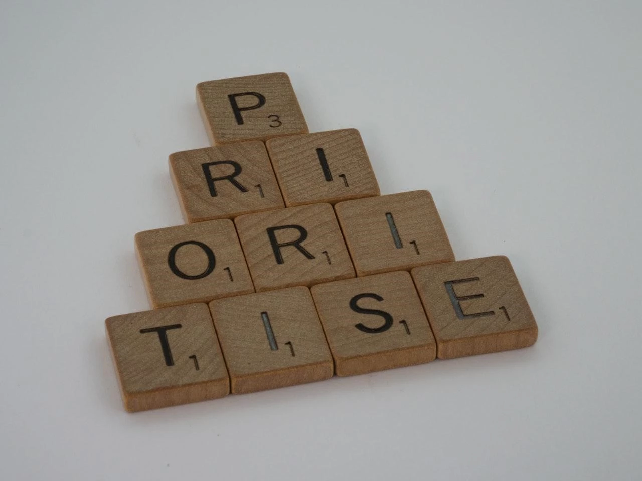 Forming the word 'Prioritise' from wooden blocks of letters