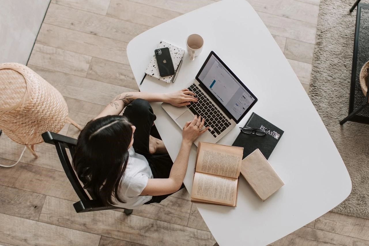 Woman working with a laptop on a desk