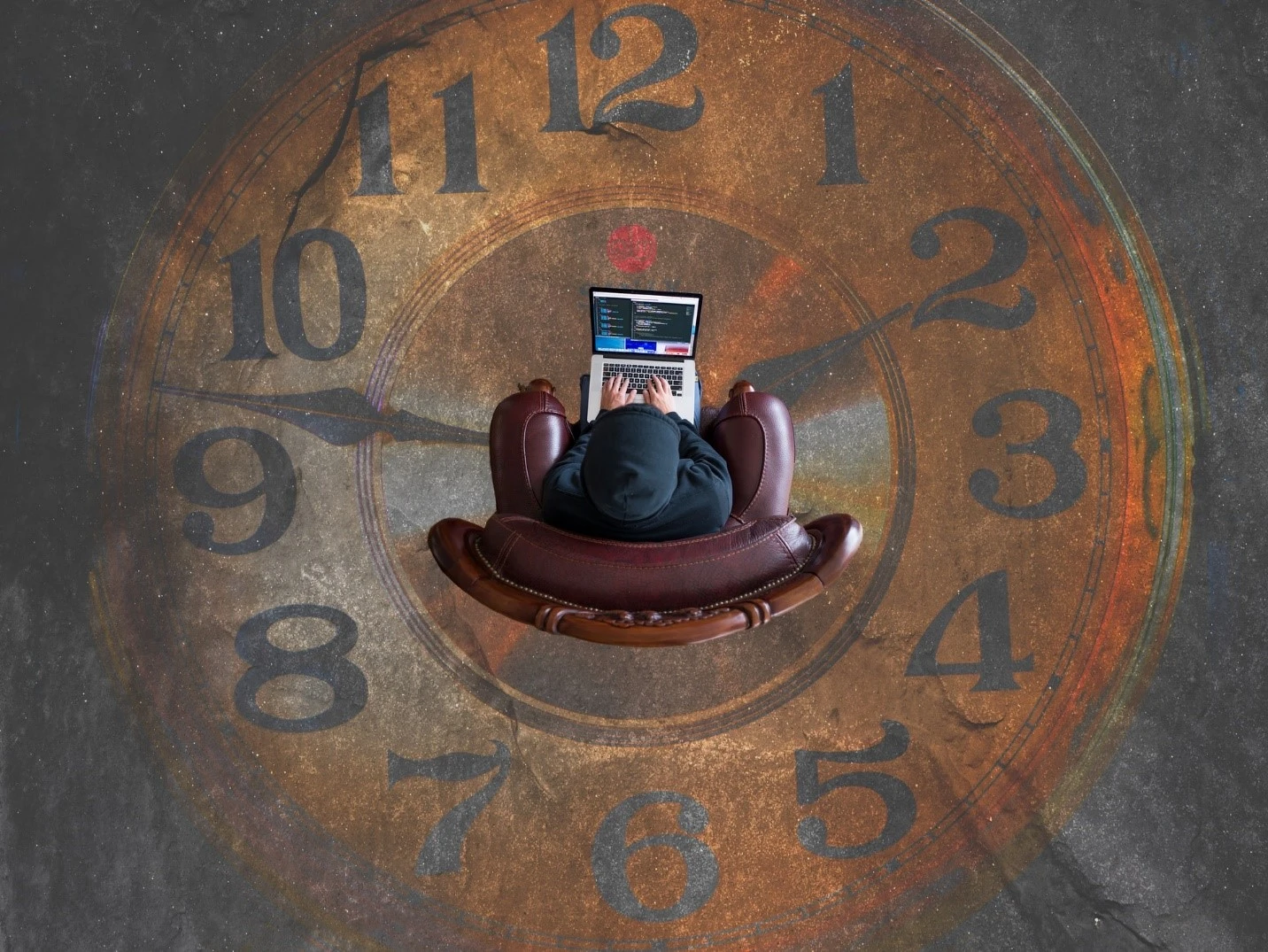 Person working while sitting in a sofa with a clock background