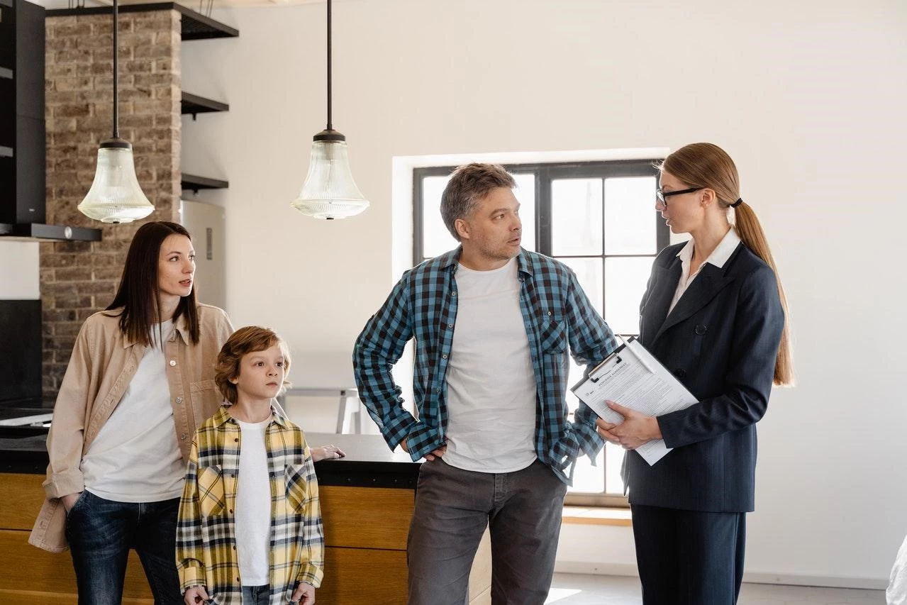 Realtor showing a house to a family