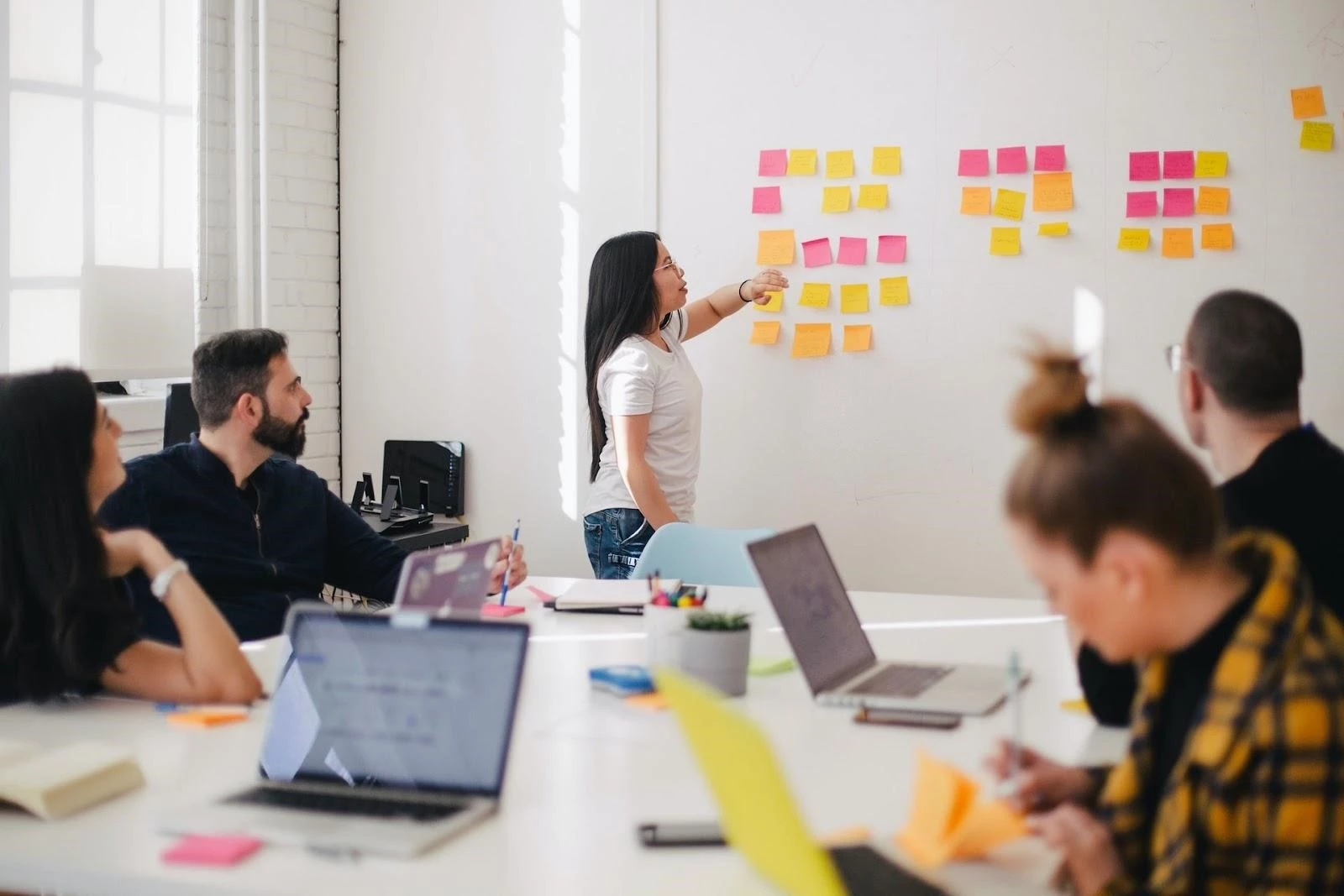 Workers discuss schedule in a meeting