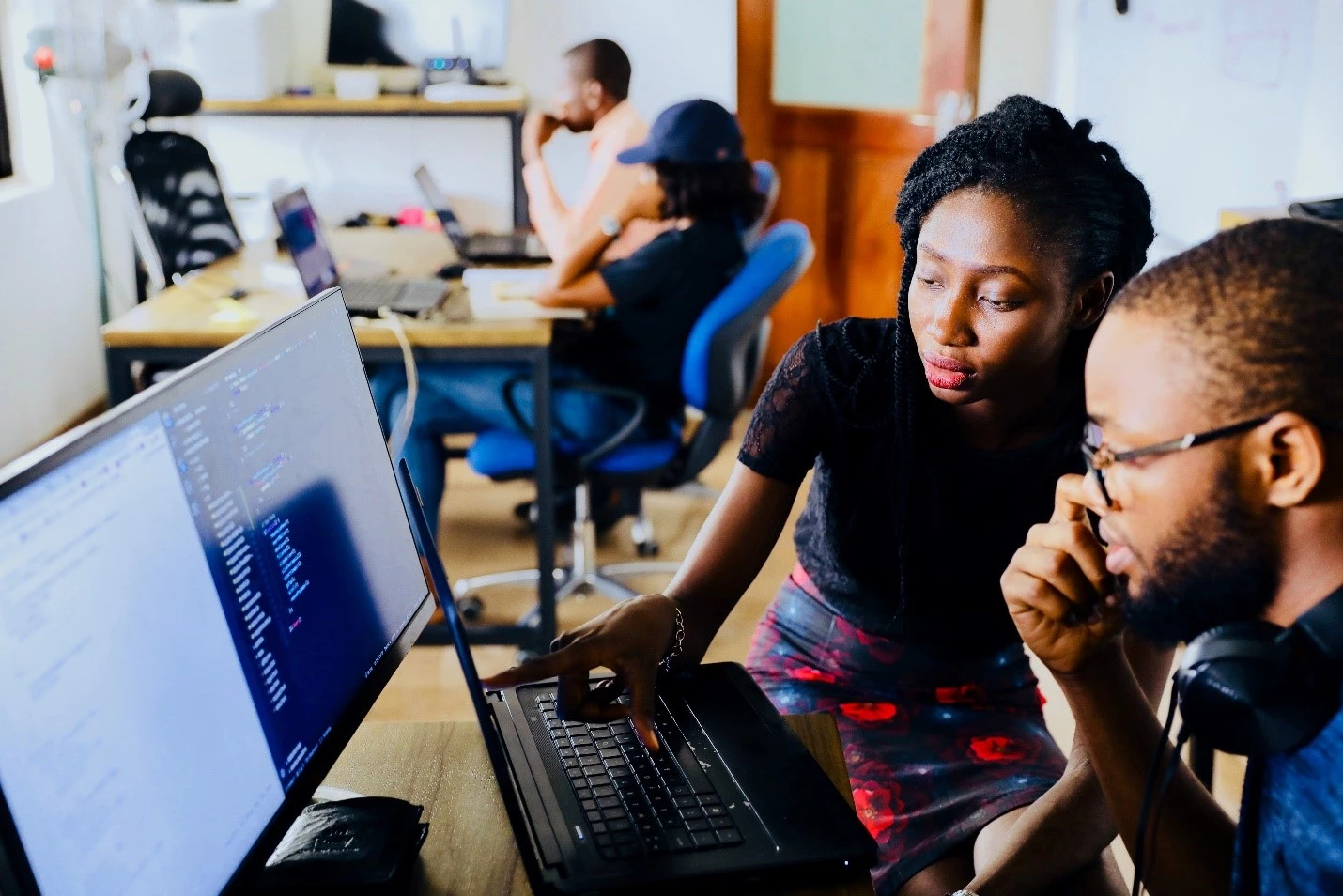 Two workers in front of computers